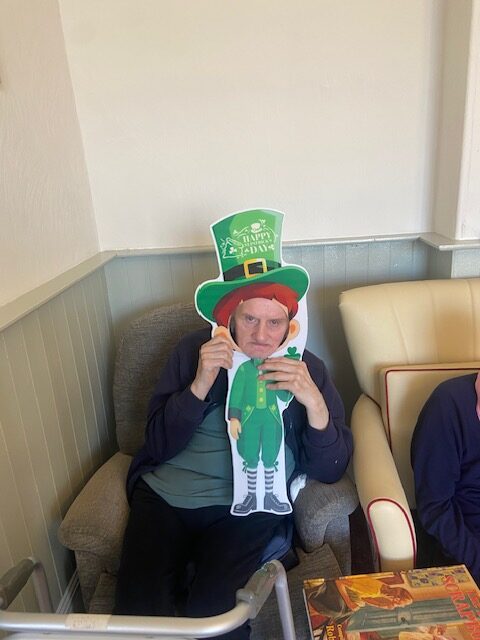 Male resident holding a St. Patricks Day decoration rotated