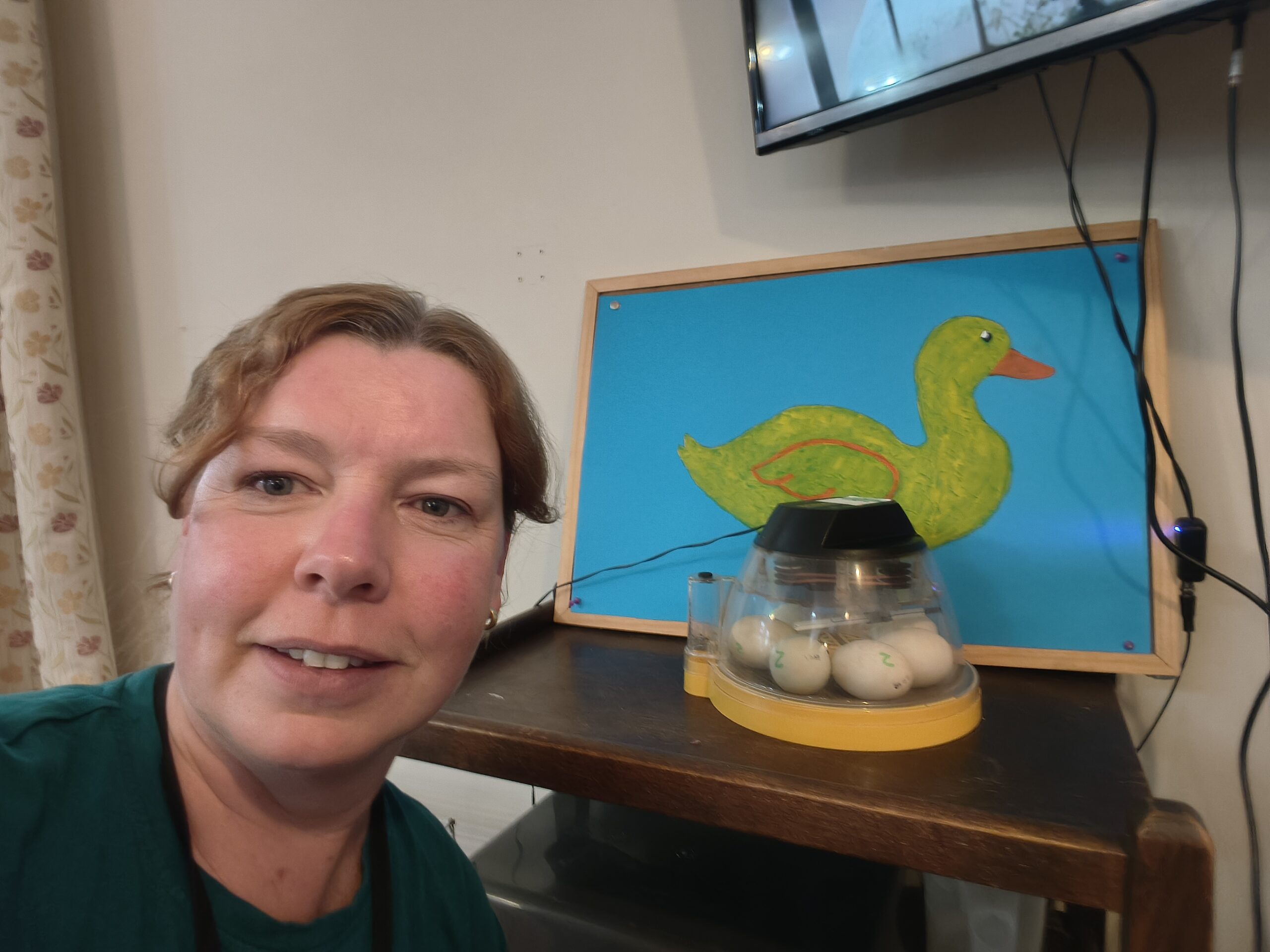 Carer selfie with the duck eggs in an incubator scaled