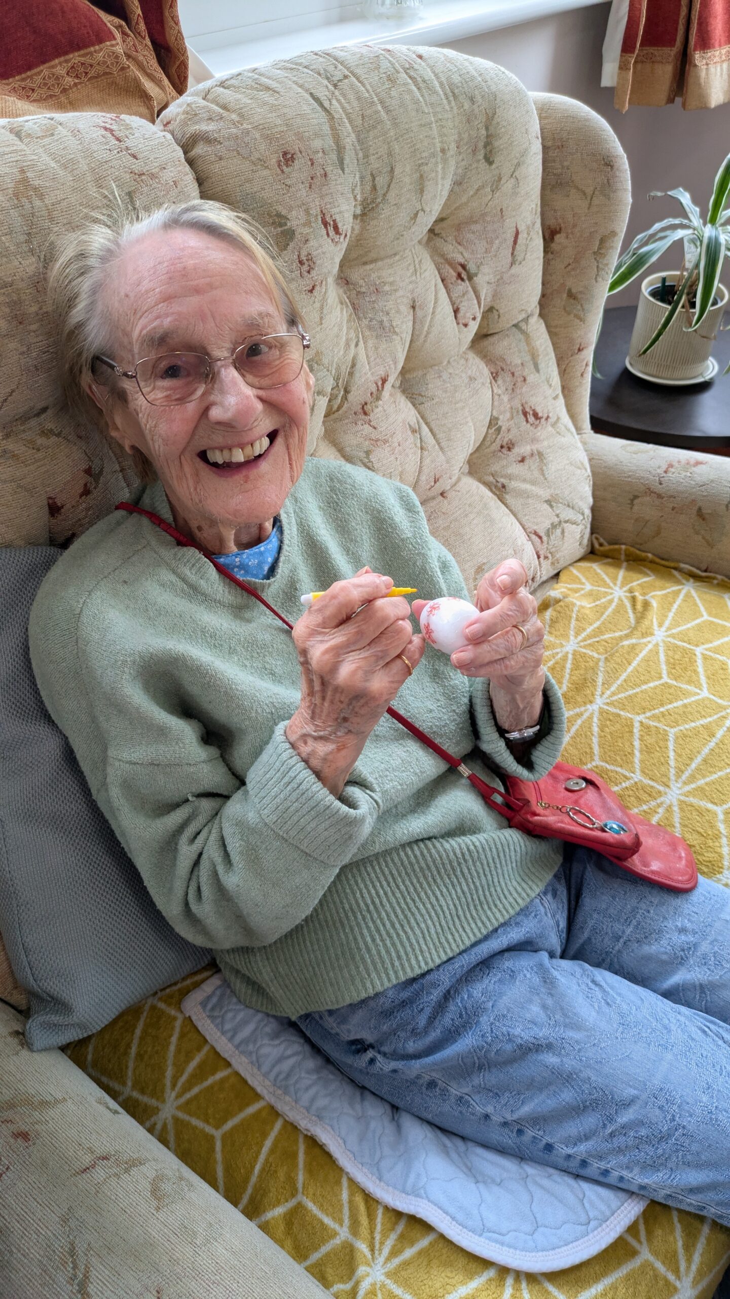 Cecily decorating her foam Easter egg with yellow felt tip pen scaled
