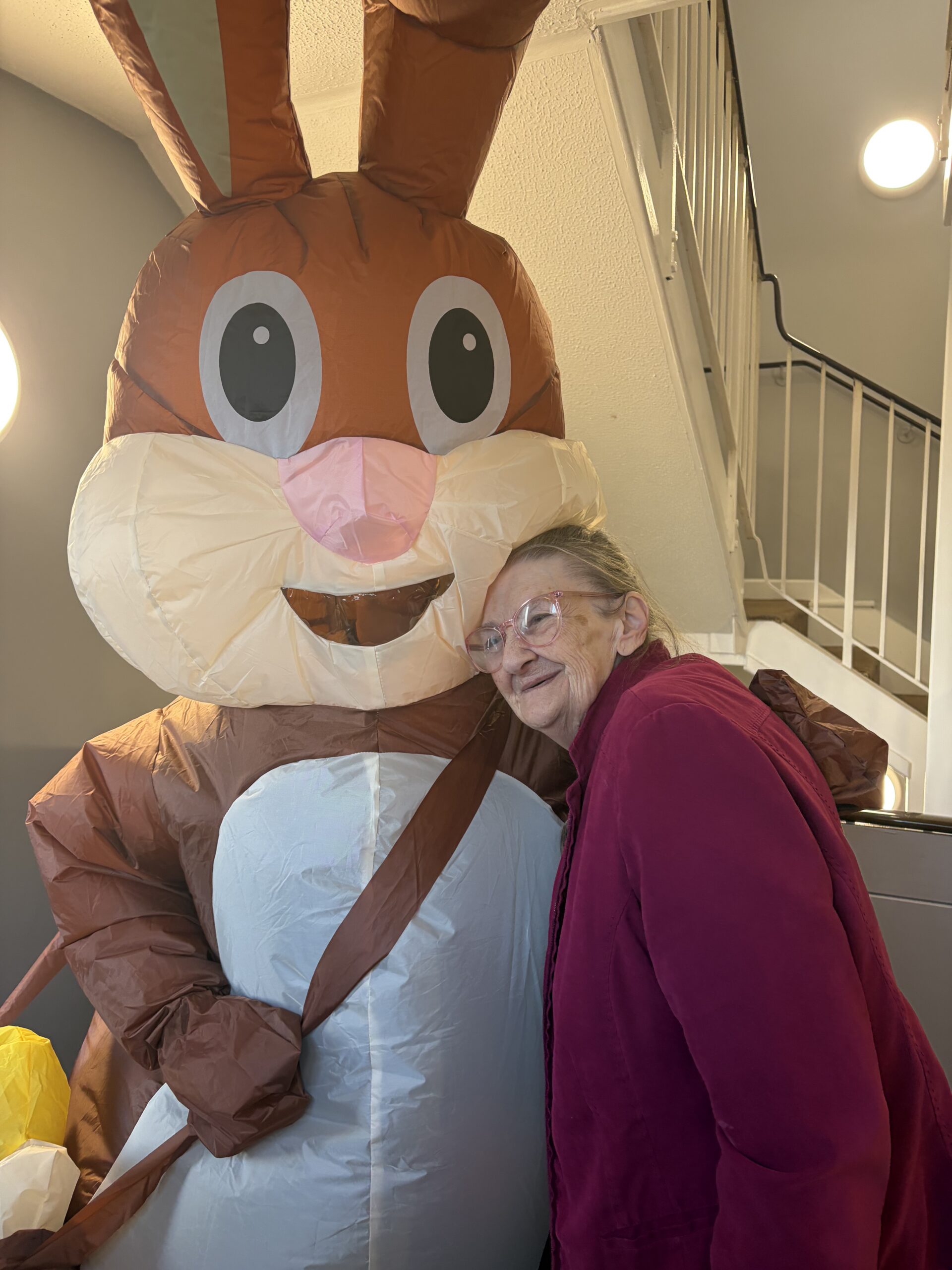 Easter bunny having a cuddle with a female resident scaled
