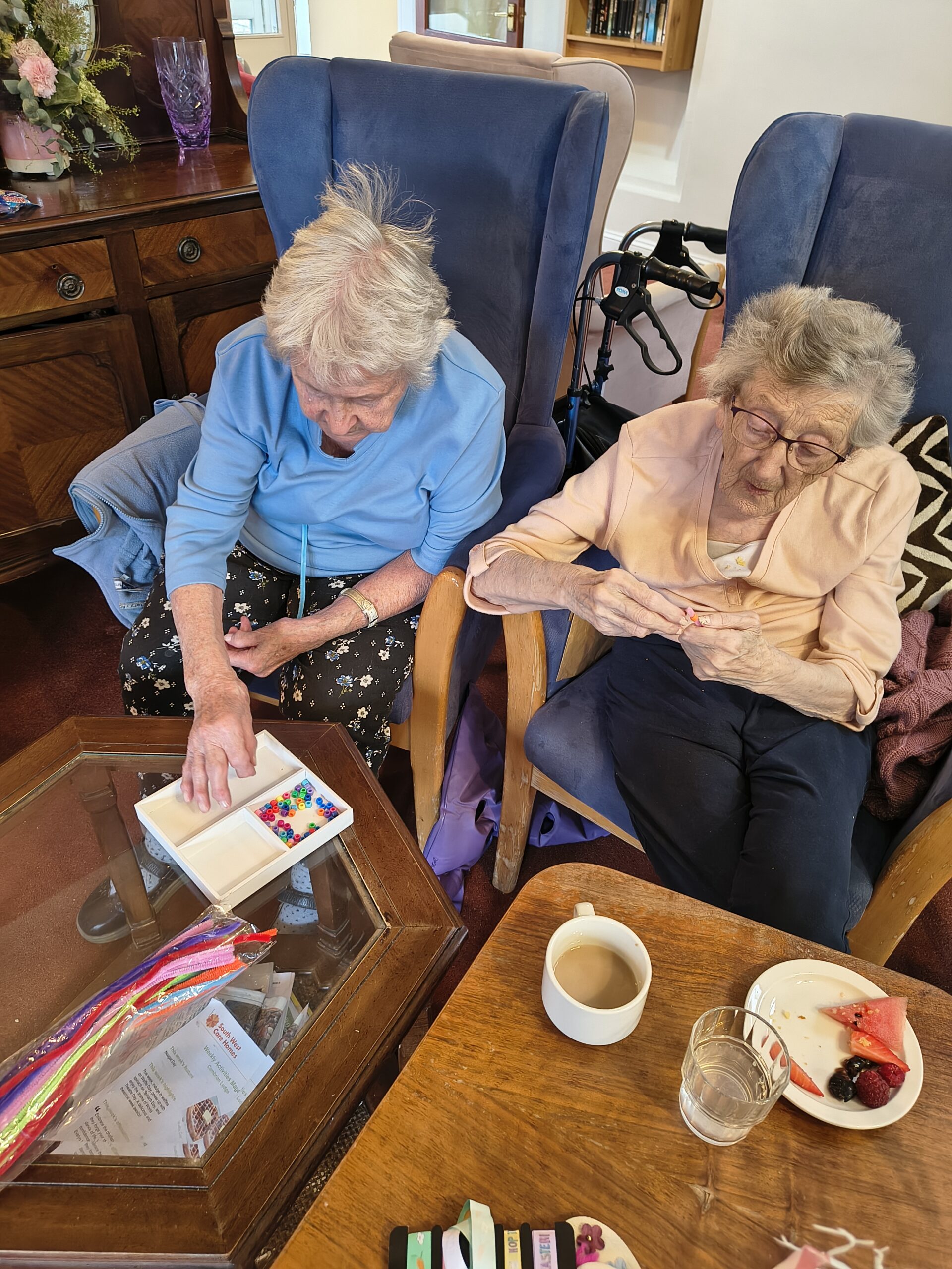Female resident threading beads onto a pipe cleaner 5 scaled