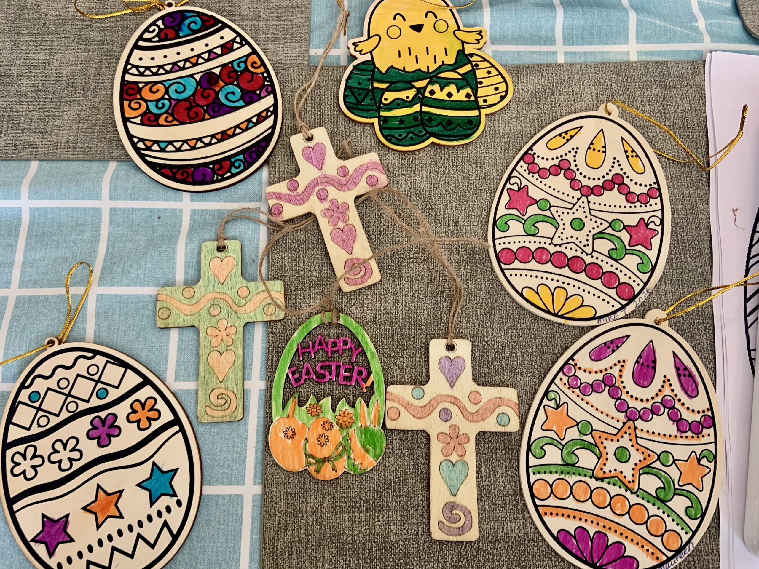 Finished crafts including patterned Easter eggs crucifixes and chicks scaled