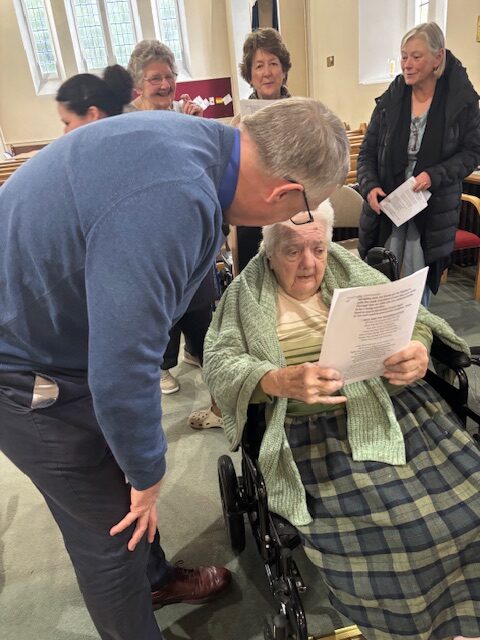 Resident speaking with a member of the church rotated