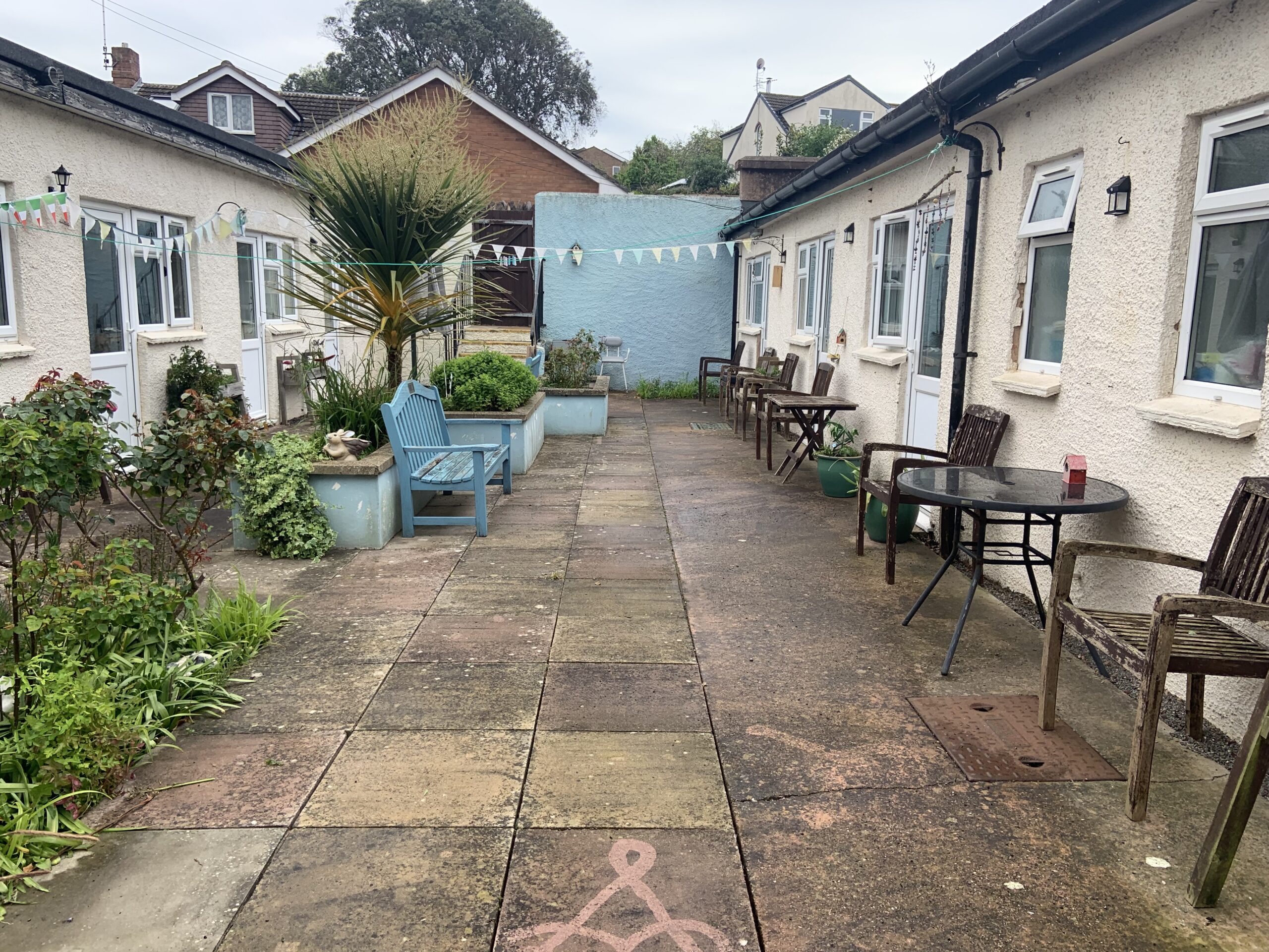 Ashfield garden with planted beds and benches from opposite end scaled