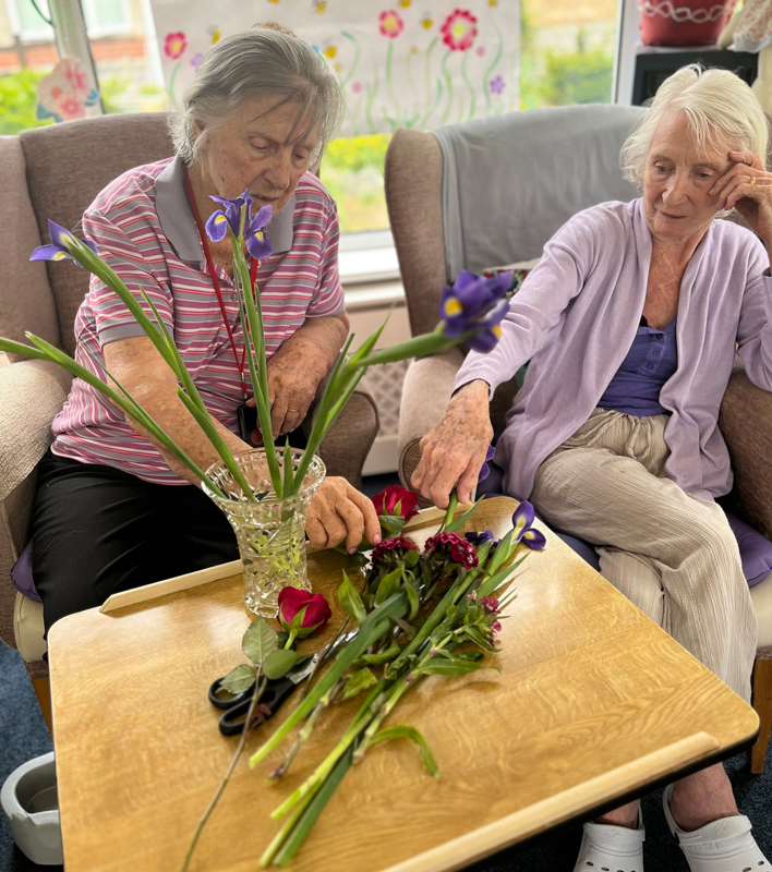 Barb and Jean choosing flowers to go in their vase
