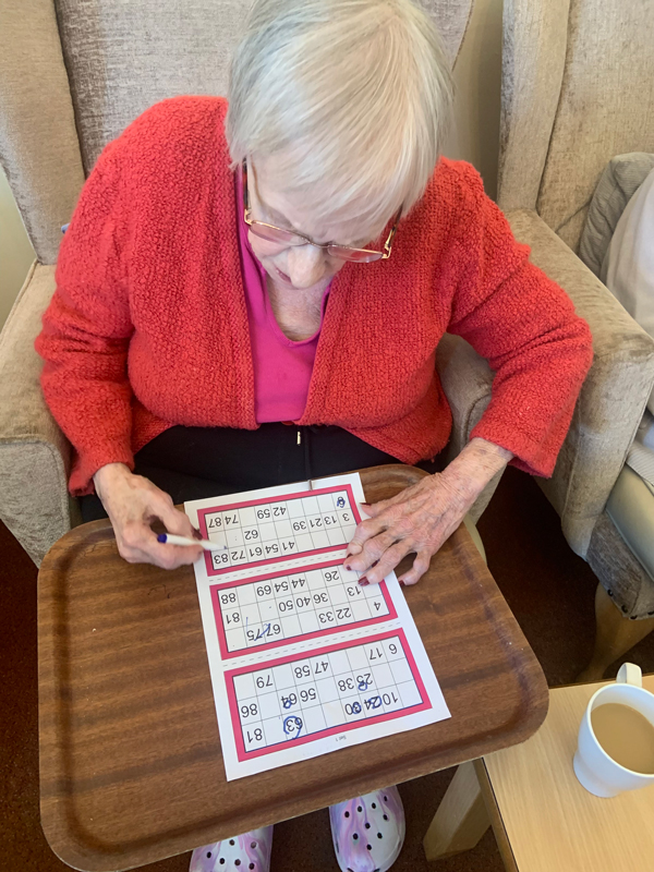 Female resident concentrating on her bingo sheet
