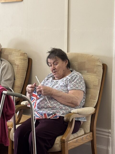 Female resident having waved her Union Jack so much it came off the stick rotated