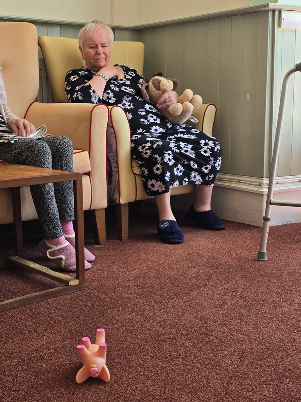 Marcia watching as her pigs land on the floor