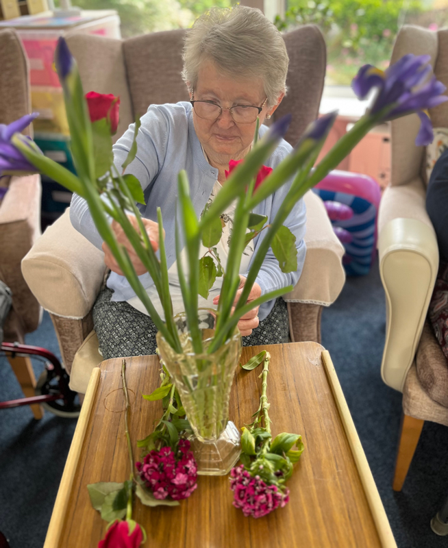 Nellie placing flowers in her vase