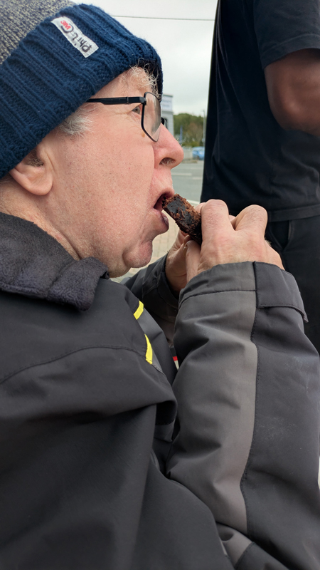 Phil eating a piece of brownie