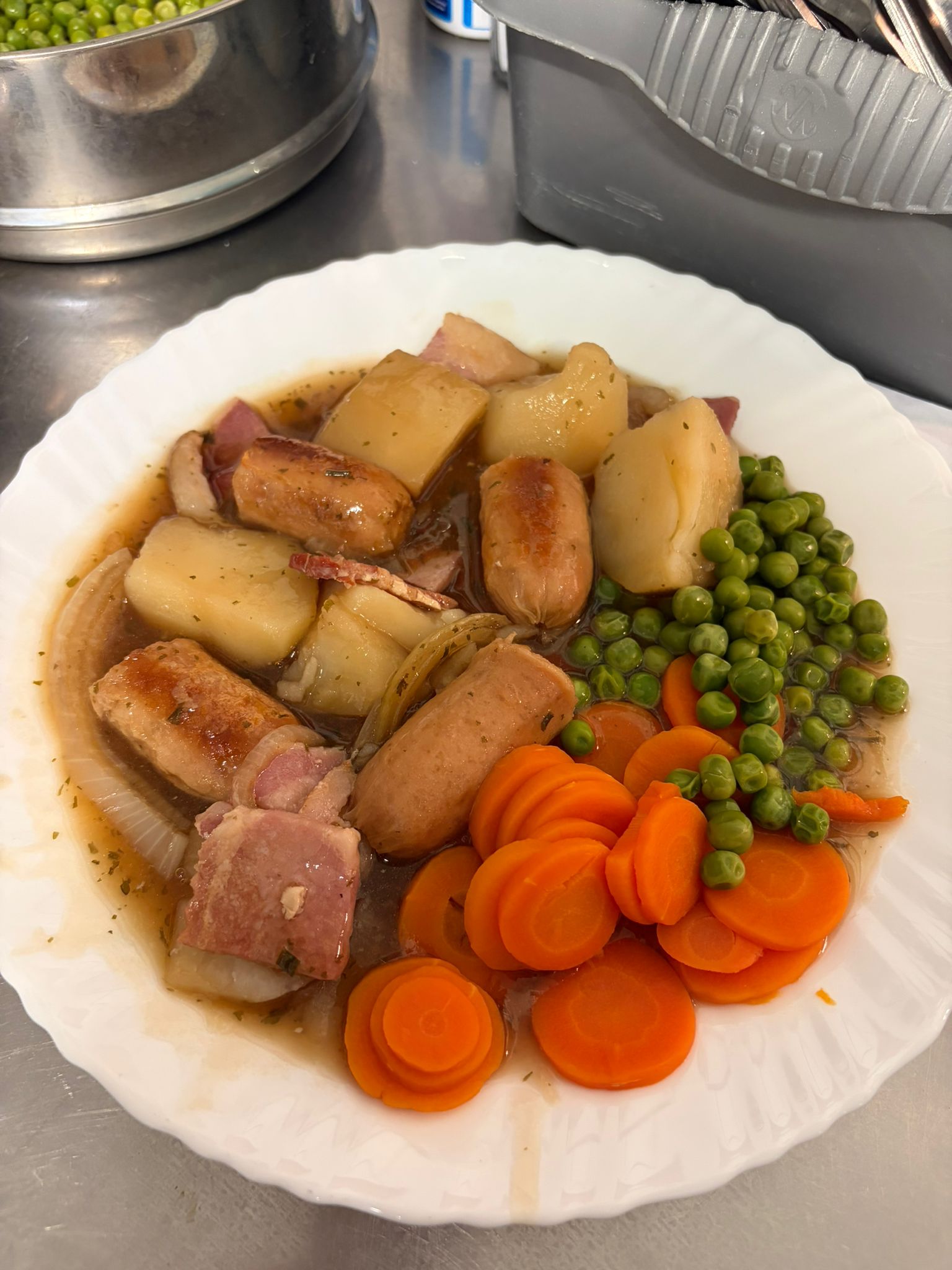 Plate of Irish Coddle with veg and lots of gravy