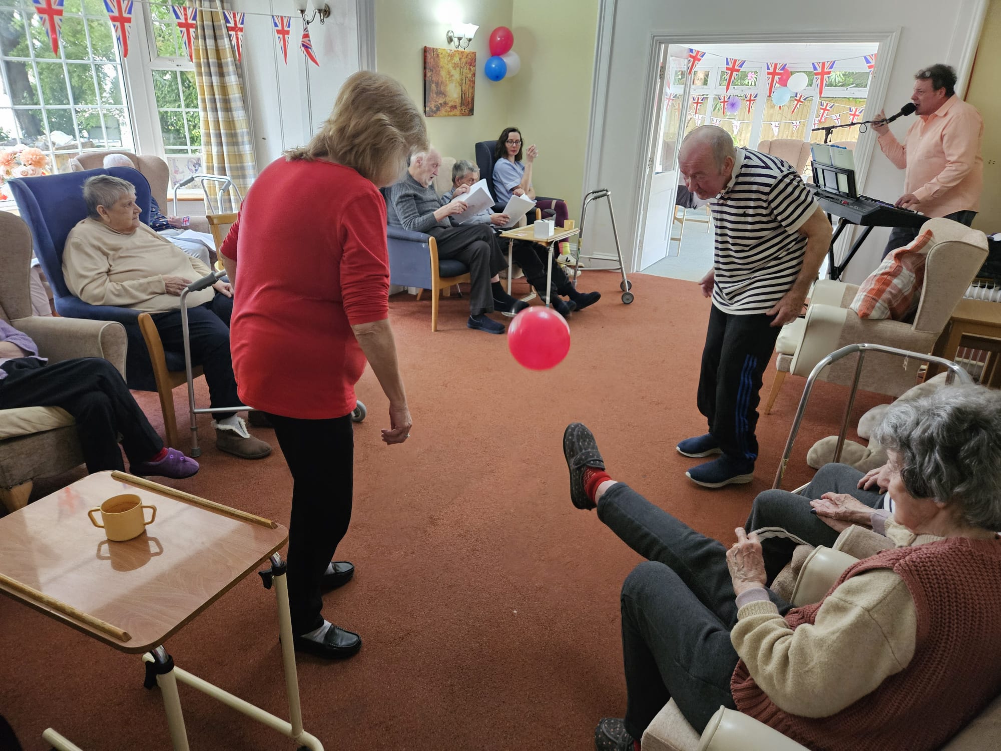 Residents listening to music and kicking a balloon around