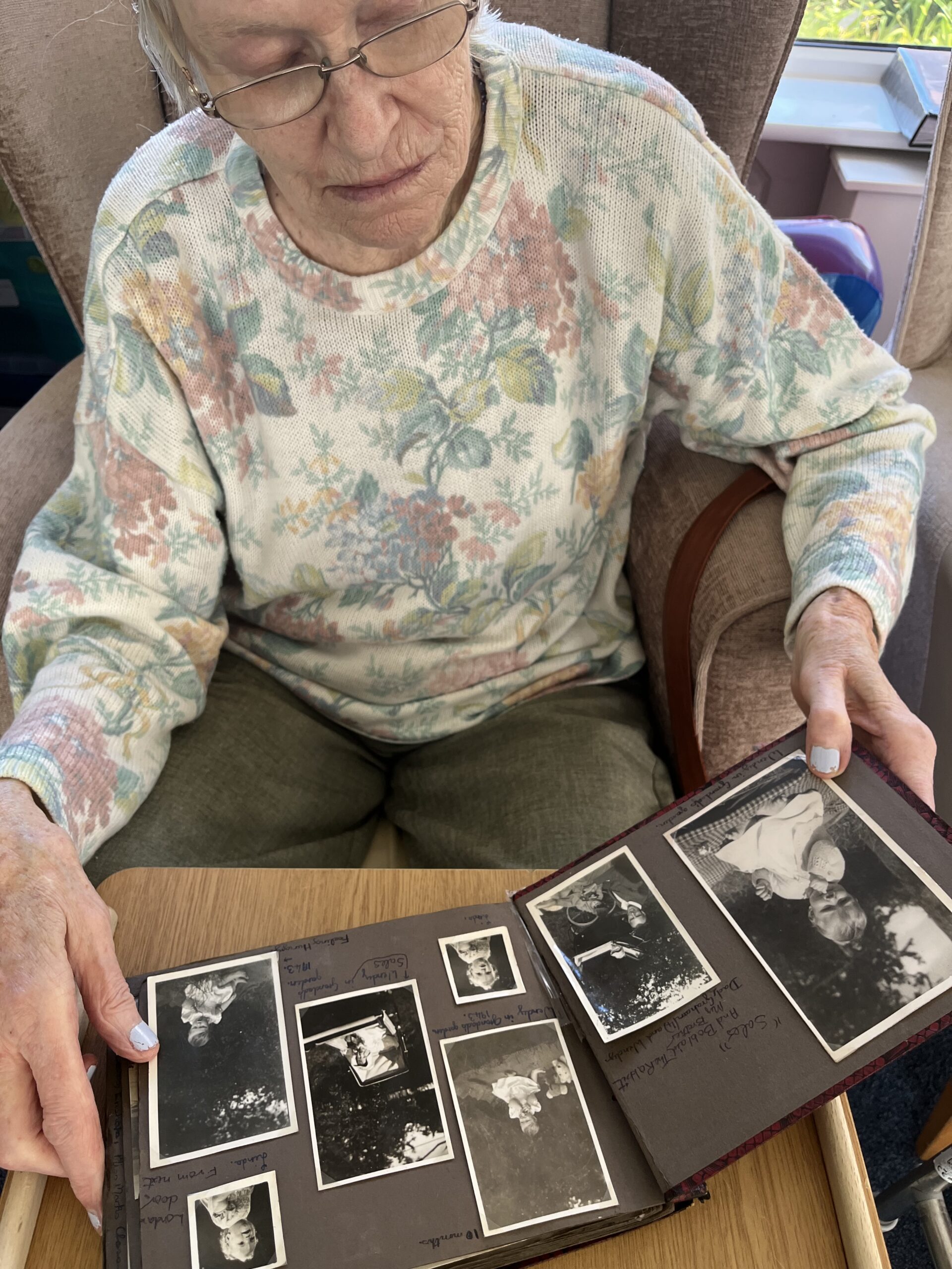 Wendy looking at photos of herself as a child scaled