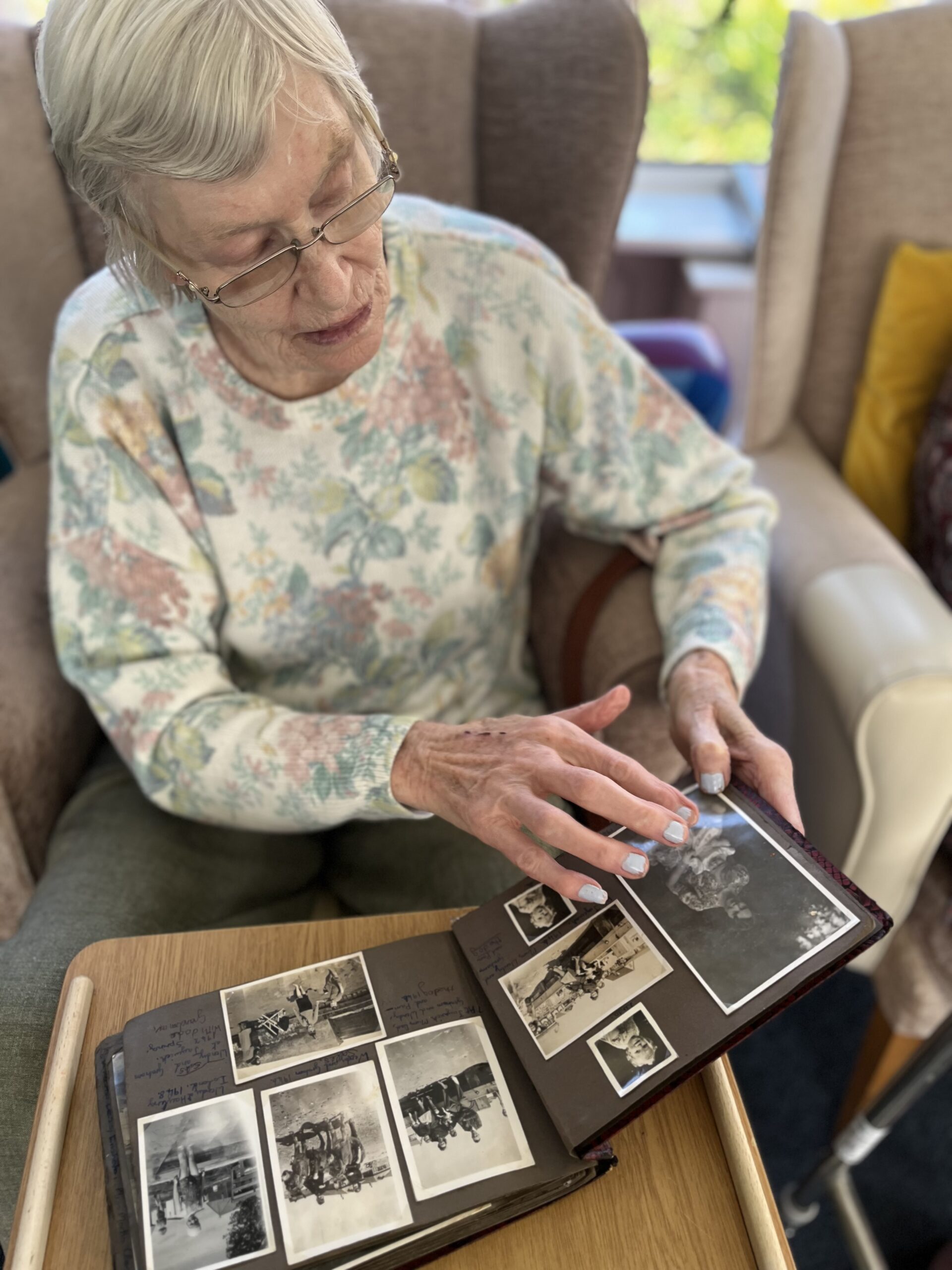 Wendy pointing out a photograph of her mother scaled